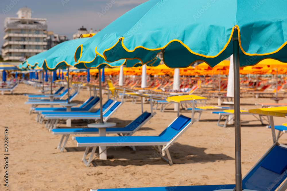 Sun umbrellas, sun beds, beach, Rimini, Italy.