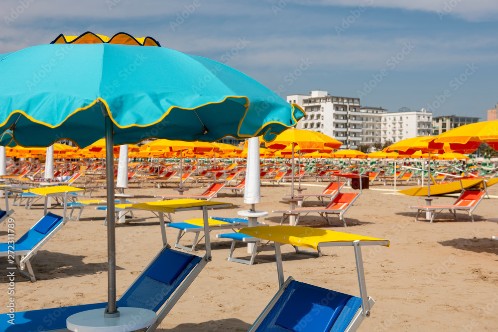Sun umbrellas, sun beds, beach, Rimini, Italy.