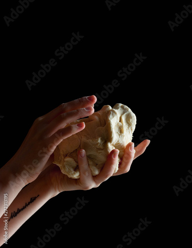 hands holding mask of dough