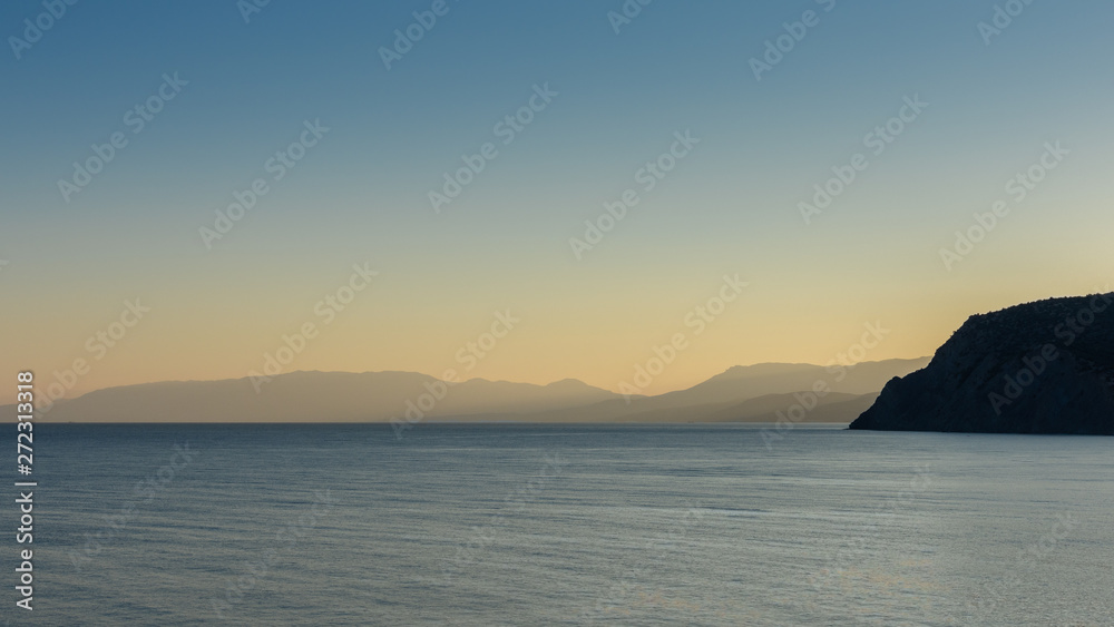 Beautiful sunset on the black sea, evening view of the mountains, Vesele bay in the Sudak Municipality of the Crimea
