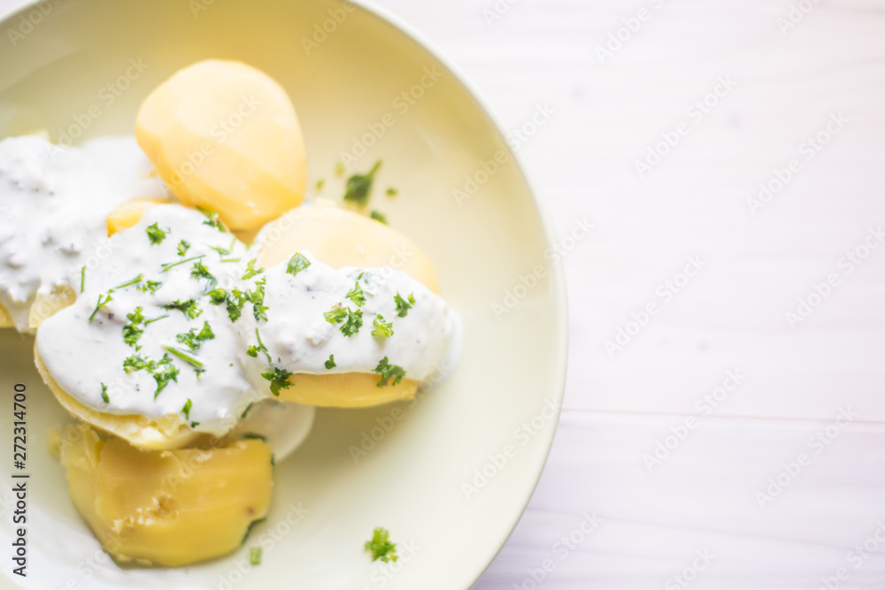 Delicious jacket potatoes. Cooked in water..Nice simple dish with sour cream. Everything on a green plate garnished with herbs. Delicious jacket potatoes. Cooked in water..Nice simple dish with sour cream. Everything on a green plate garnished with herbs.