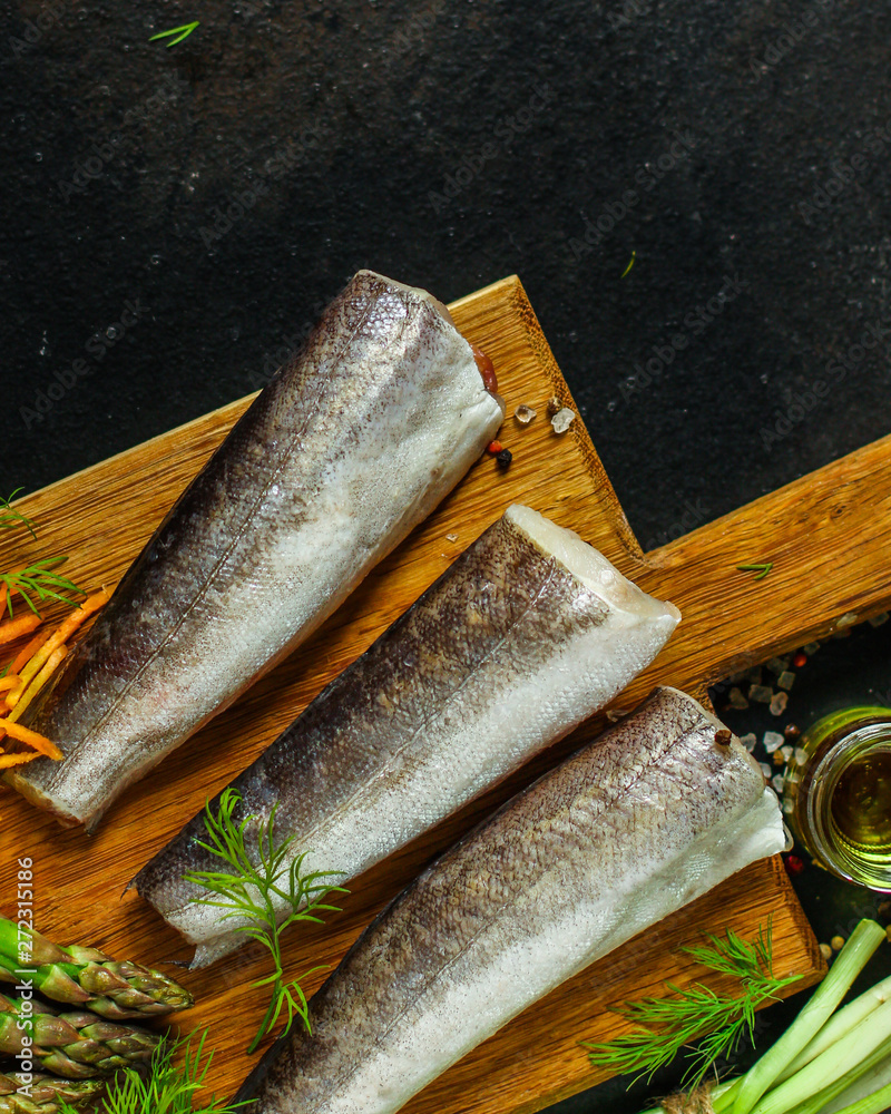 fish raw hake (set of ingredients for cooking). food background. top view. copy space fish raw hake (set of ingredients for cooking). food background. top view. copy space