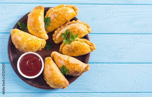 Latin American baked beef empanadas with sauce