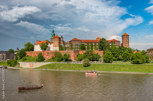 Wawel Castle and Wawel cathedral in the sun over the Vistula river on cloudy afternoon