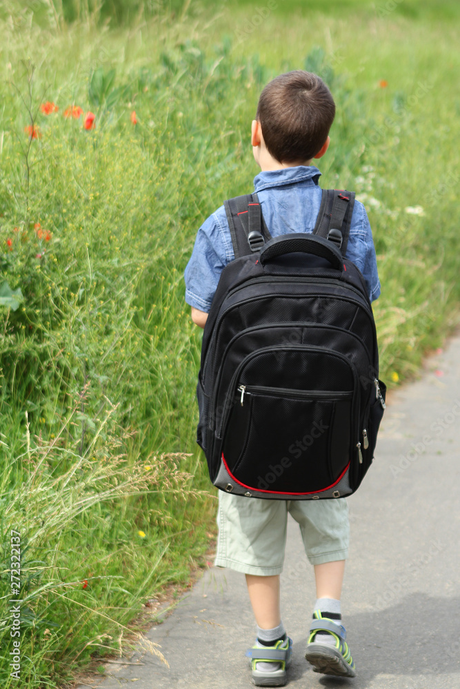 boys with school bags go to school on the track, Back to school concept boys with school bags go to school on the track, Back to school concept