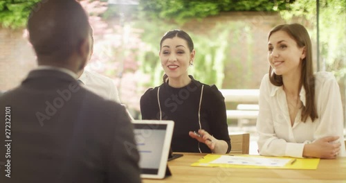 4K Attractive multi ethnic corporate group in a meeting, could be job interview or business negotiations. Slow motion.