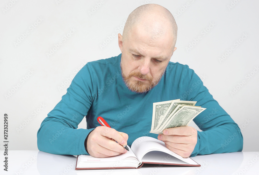 businessman writes down his financial income in a notebook businessman writes down his financial income in a notebook