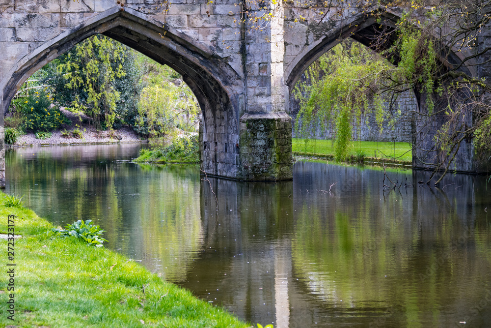 Reflections in the river, under the archway