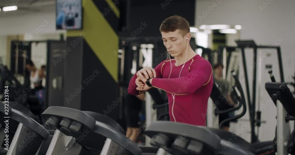 Runner looking at the timer on the smartwatch and rejoices with his results Runner looking at the timer on the smartwatch and rejoices with his results