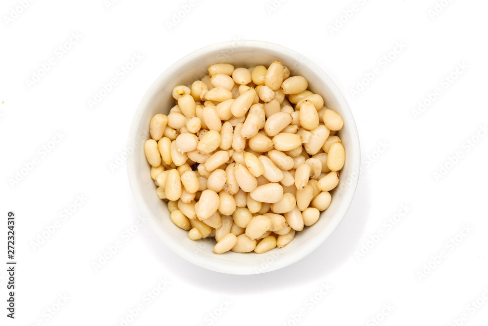 Pine nut in ceramic bowl on white background, top view Pine nut in ceramic bowl on white background, top view