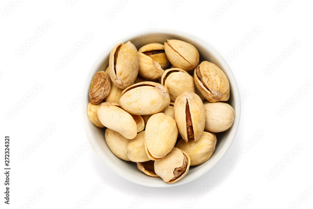 Pistachio in ceramic bowl on white background, top view