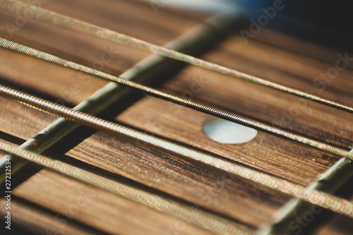 Macro close up shot of acoustic guitar strings on sun shine. Music and guitar playing concept