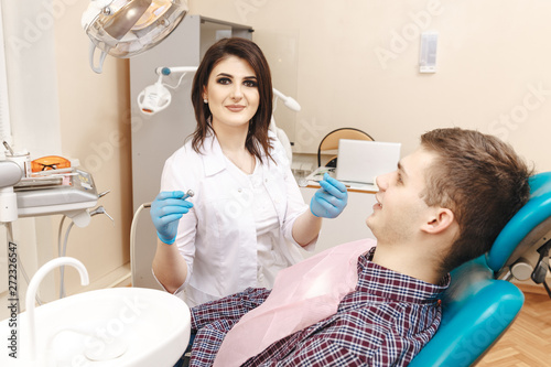 Dentist taking care about male patient s teeth. Professional cleaning