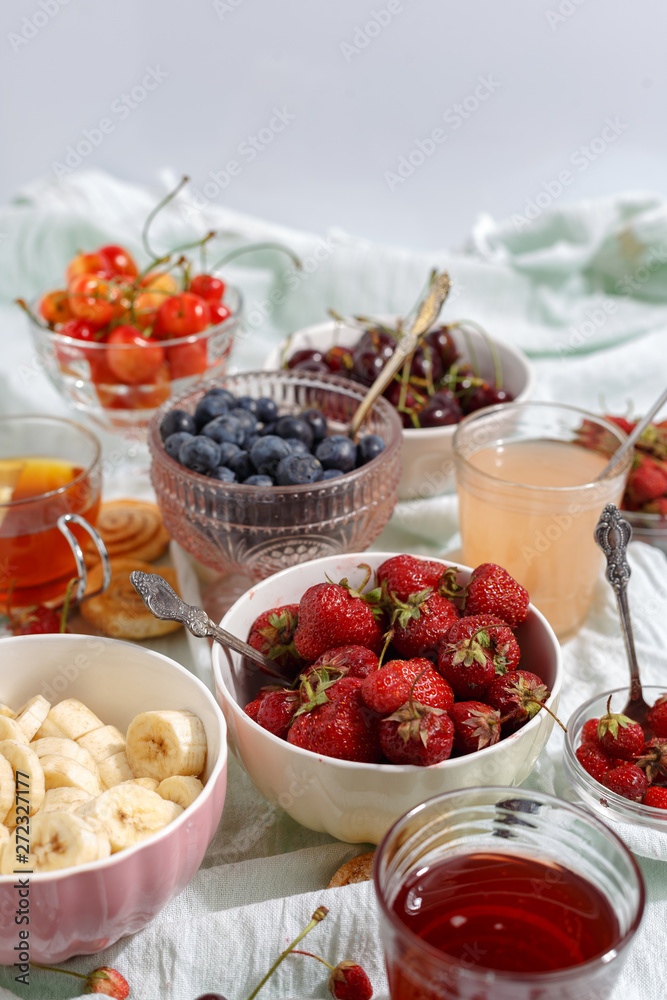 Summer berries strawberries, blueberries, sweet cherries in vases on the table. Top view Summer berries strawberries, blueberries, sweet cherries in vases on the table. Top view