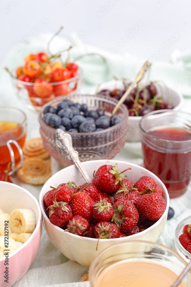 Summer berries strawberries, blueberries, sweet cherries in vases on the table. Top view Summer berries strawberries, blueberries, sweet cherries in vases on the table. Top view