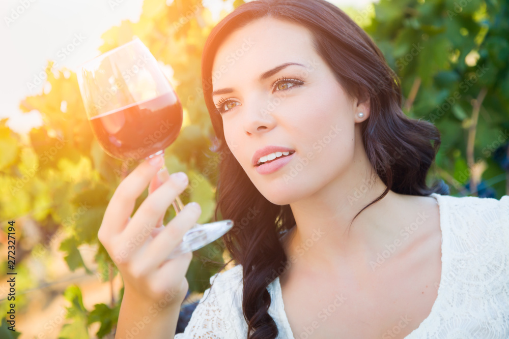 Beautiful Young Adult Woman Enjoying Glass of Wine Tasting In The Vineyard