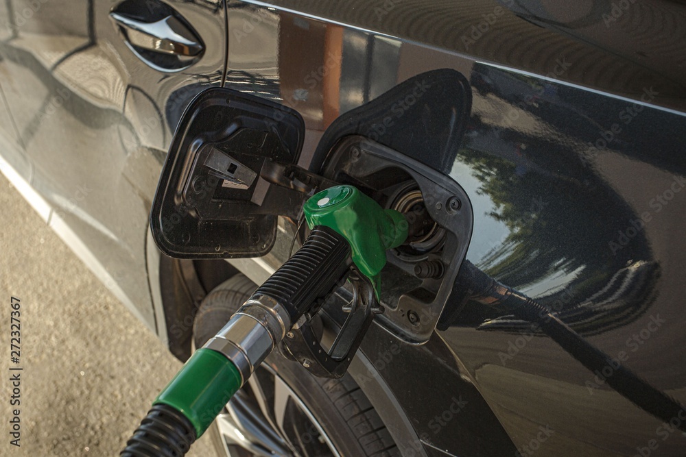 Black car filling fuel on gasoline station. Transportation concept. Beautiful backgrounds. Black car filling fuel on gasoline station. Transportation concept. Beautiful backgrounds.