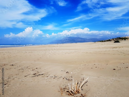 Sandy dunes and beach in Patara on background of mountains and sky. Turkey