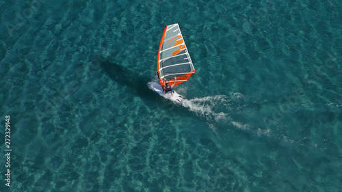 Aerial photo of surfer cruising in high speed in Mediterranean destination bay with deep blue sea © aerial-drone