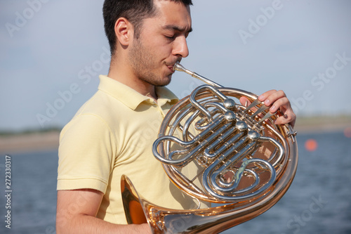 French horn instrument. Player hands playing horn music brass instrument photo