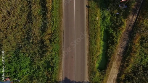 Beautiful aerial view of car driving on country road in forest drone forest road car nature flight fly helicopter rural shot top transport travel tree automobile country drive landscape slow motion
