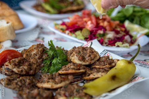 Thin turkish pita bread covered with minced meat and onions with flavored lemon in  Tarsus city. Turkish called 'Lahmacun'. This is the smallest one called 'bird eye'.
