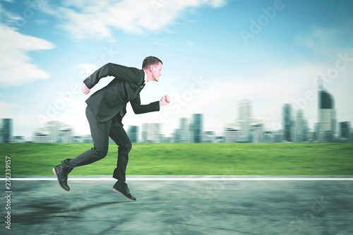 American businessman sprinting on the road © Creativa Images