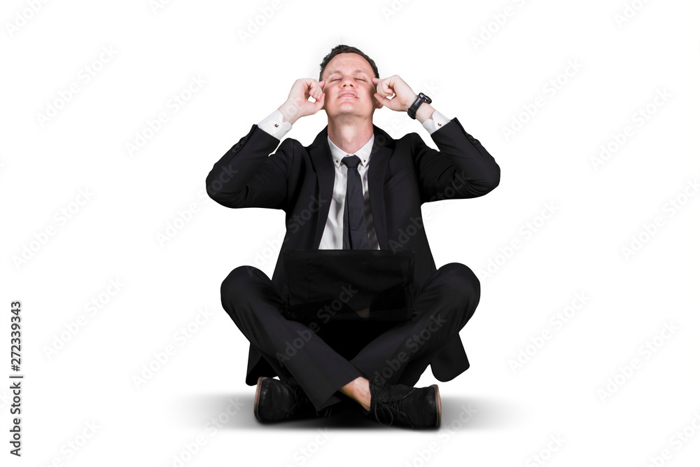 Businessman meditate with eyes closed on studio Businessman meditate with eyes closed on studio