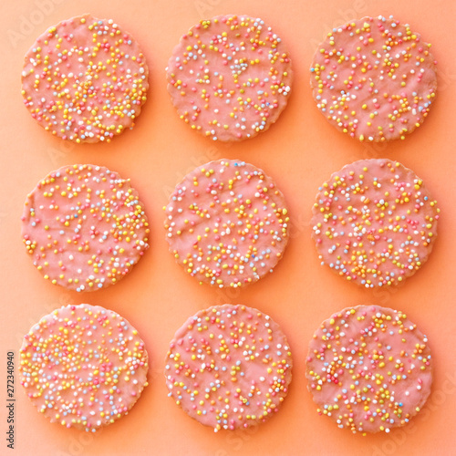 Pattern of pink biscuits with hundreds and thousands.