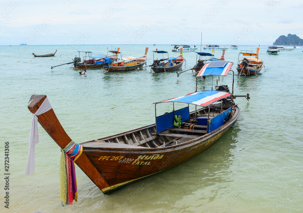 Thai long-tail wooden boat on blue sea