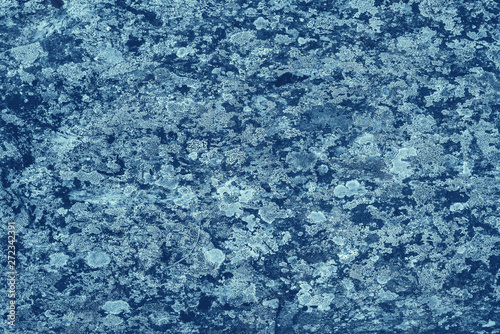 Vintage blue background. Rough painted wall of sapphire color. Imperfect plane of blue colored. Uneven old decorative toned backdrop of cyan tint. Texture of sapphirine hue. Ornamental stony surface.