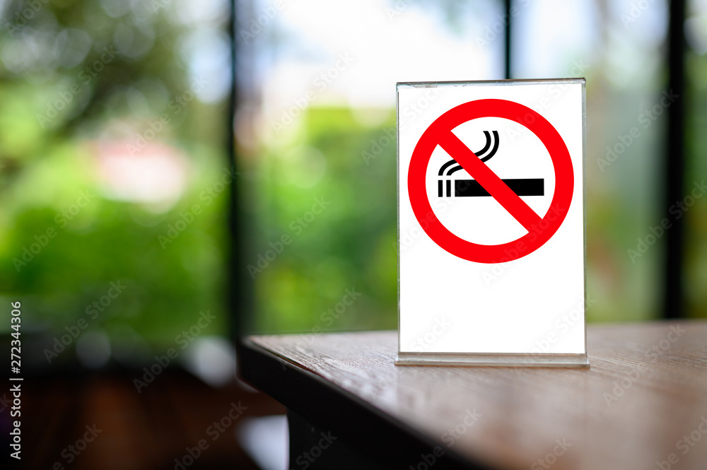 no smoking sign with shopping place background on wooden table no smoking sign with shopping place background on wooden table