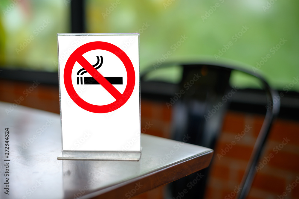 no smoking sign with shopping place background on wooden table no smoking sign with shopping place background on wooden table