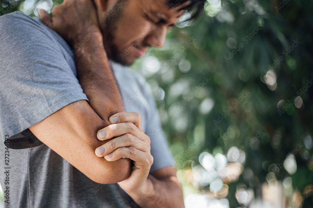 Pain in elbow , Asian young men with elbow pain, health care concepts, Health Care Concept