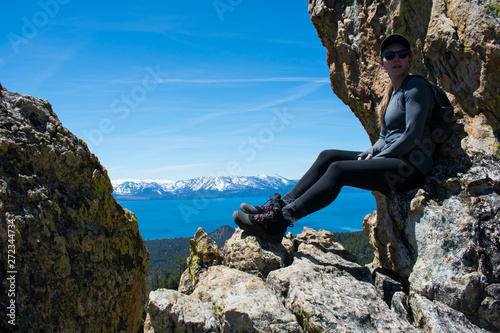 Woman on a mountain looking down at Lake Tahoe
