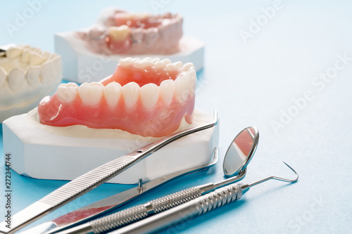 Close up , Complete denture or full denture on blue background. photo