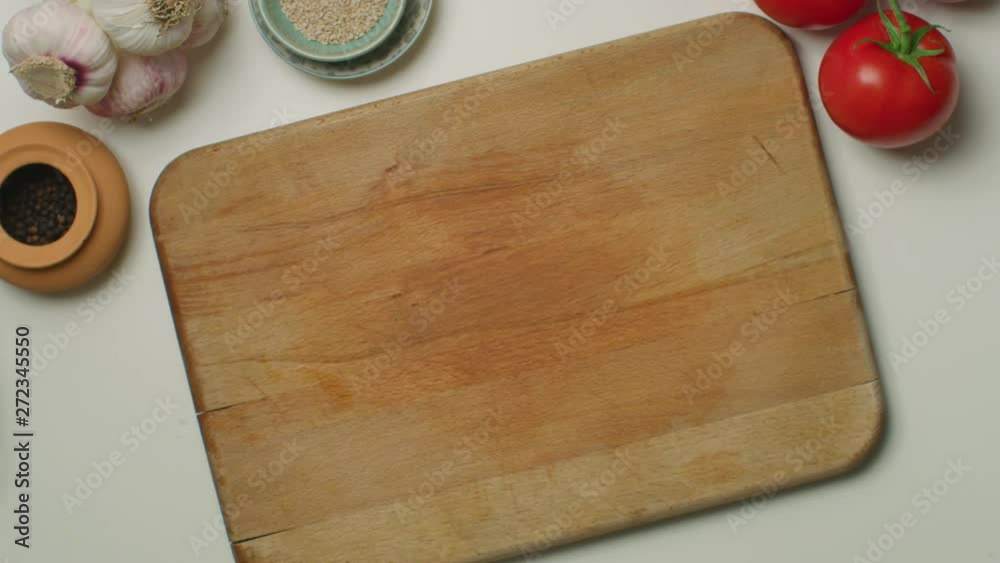 Hands cutting a hard-boiled egg on a wooden board
