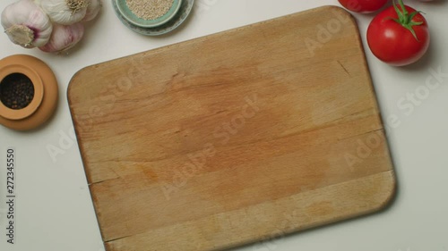 Hands cutting a hard-boiled egg on a wooden board
