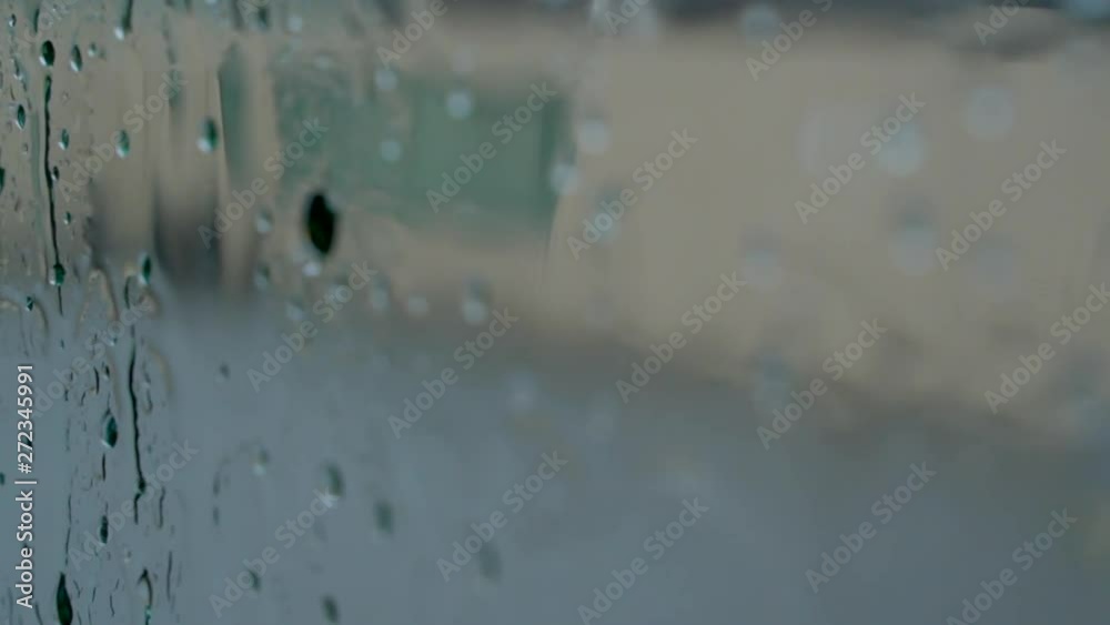slow motion rain droplet on a glass window