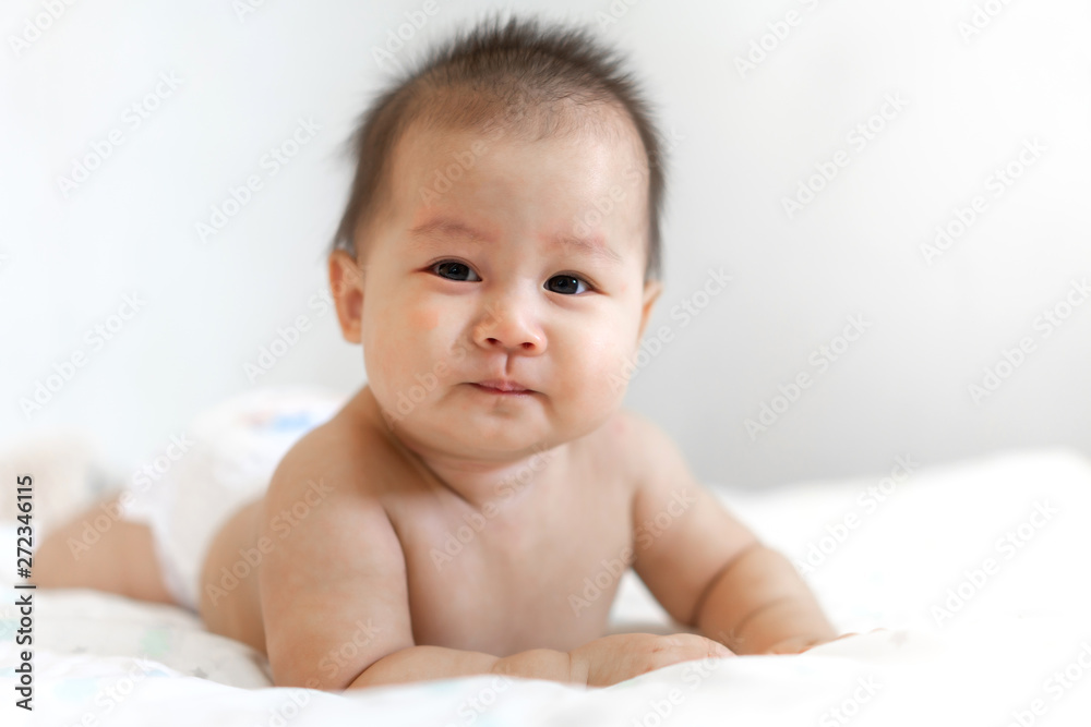 Portrait of happy smile baby relaxing on the bed Portrait of happy smile baby relaxing on the bed