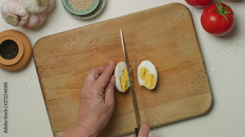 Cutting boiled egg on a wooden board