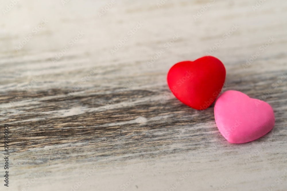 Colorful red and pink hearts against rustic white background. Concept of love, Saint Valentine day, healthy lifestyle, heart disease, and relationships Colorful red and pink hearts against rustic white background. Concept of love, Saint Valentine day, healthy lifestyle, heart disease, and relationships