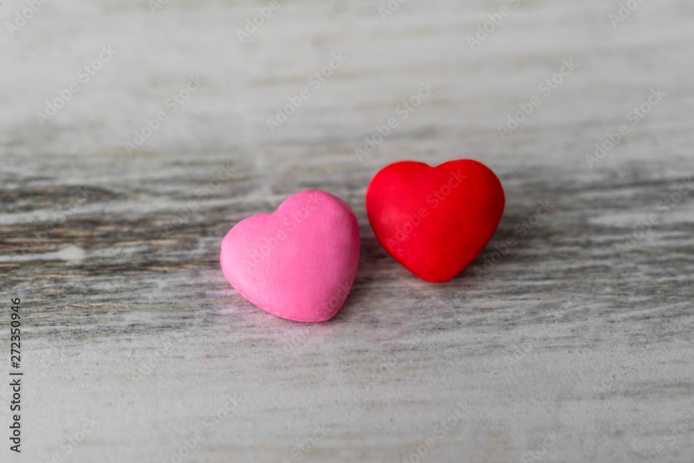 Colorful red and pink hearts against rustic white background. Concept of love, Saint Valentine day, healthy lifestyle, heart disease, and relationships Colorful red and pink hearts against rustic white background. Concept of love, Saint Valentine day, healthy lifestyle, heart disease, and relationships