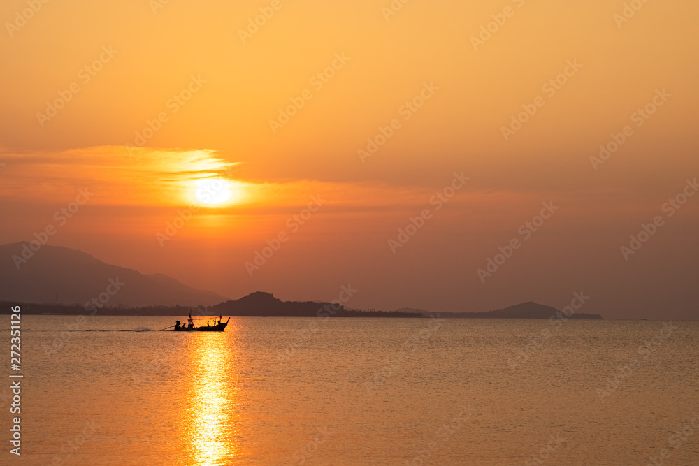 beautiful sky evening atmosphere sunset over sea with fishing boat