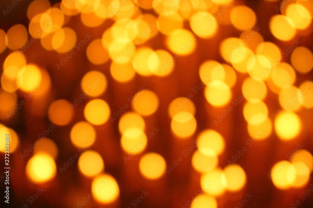 Many candles illuminate in the dark, filmed as blurred Many candles illuminate in the dark, filmed as blurred