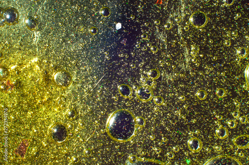Abstract golden background transparent slime with particles and bubbles