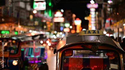 4K Traditional Thai taxi Tuk Tuk awaits tourists along the road at chinatown photo