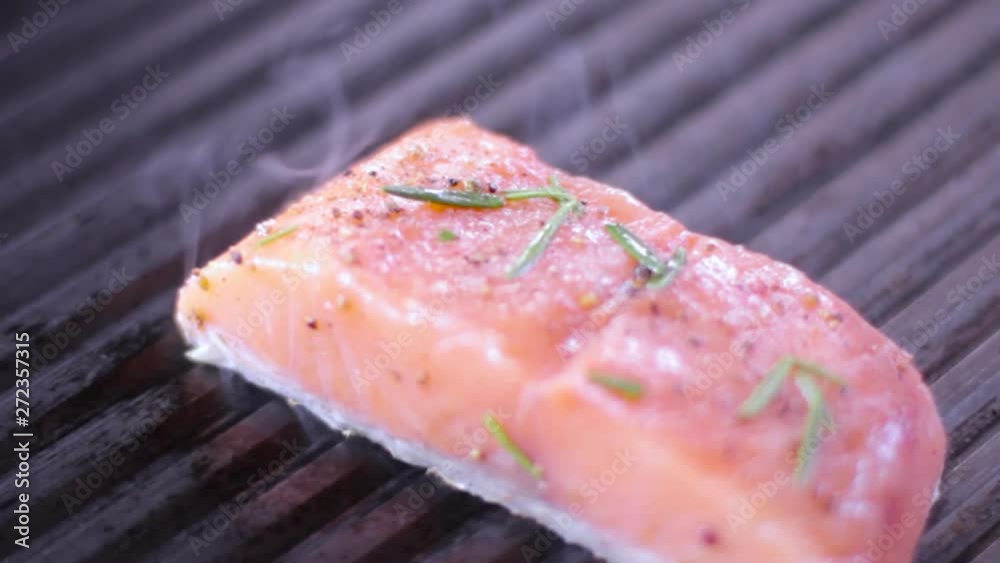 Cook prepares salmon on the grill Cook prepares salmon on the grill