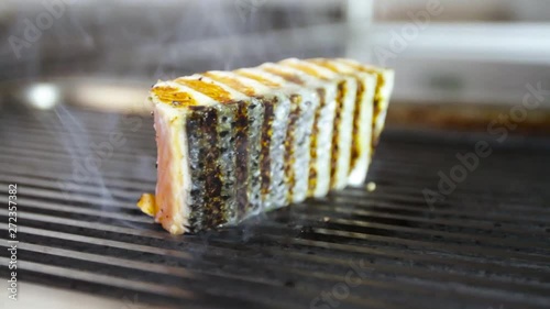 Cook prepares salmon on the grill photo