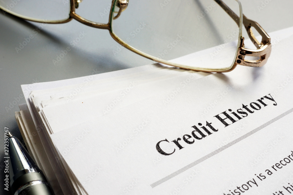 Credit history report papers and pen. Credit history report papers and pen.